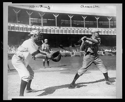 [Frank Chance, Chicago NL baseball player, standing at home plate, with bat in hand about to swing, the catcher, Pat Moran, Chicago NL, stands to the left ready to receive the pitched ball]