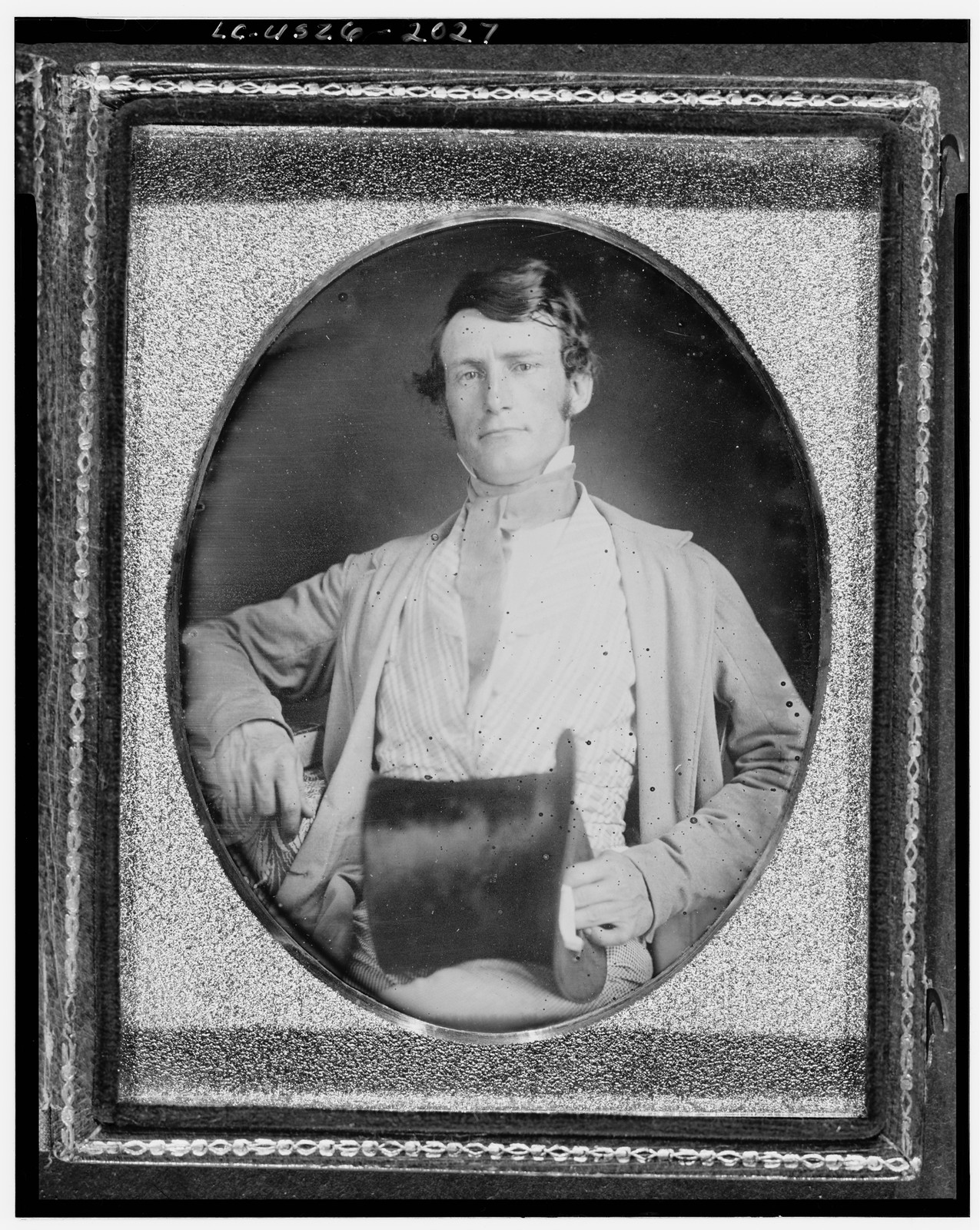 Daguerreotype portrait of a seated man in an oval mat, 1840 — historic photograph