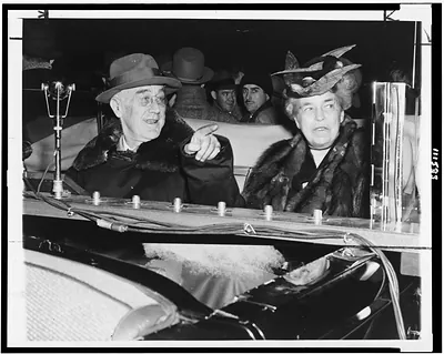 [President Franklin Roosevelt pointing out something of interest to Mrs. Roosevelt, as they ride in automobile through Poughkeepsie, New York, on the last lap of the president's final campaign tour through the Hudson River Valley]