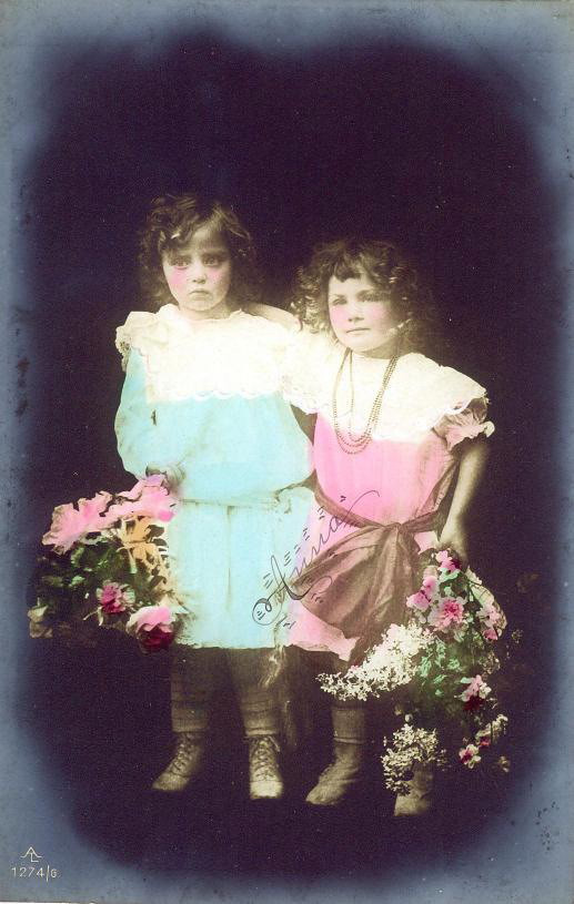Two girls in hand-tinted studio portrait with flowers — historic image