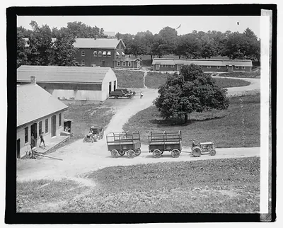 Tractor pulling two wagons on a farm road