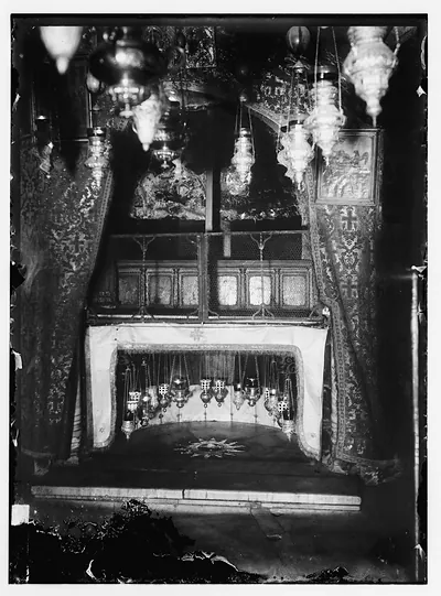Ornate church interior with hanging lamps and a silver star