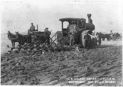 J.N. Welsby breaking sod, S.D.