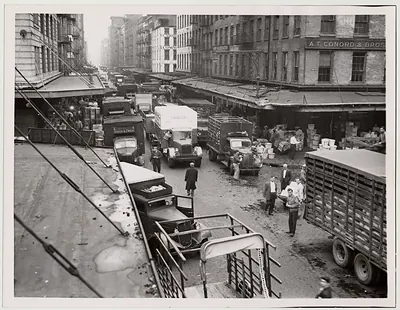 Trucks lined up on a cobbled city street