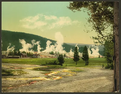 Geyser steam and log buildings, Yellowstone Park