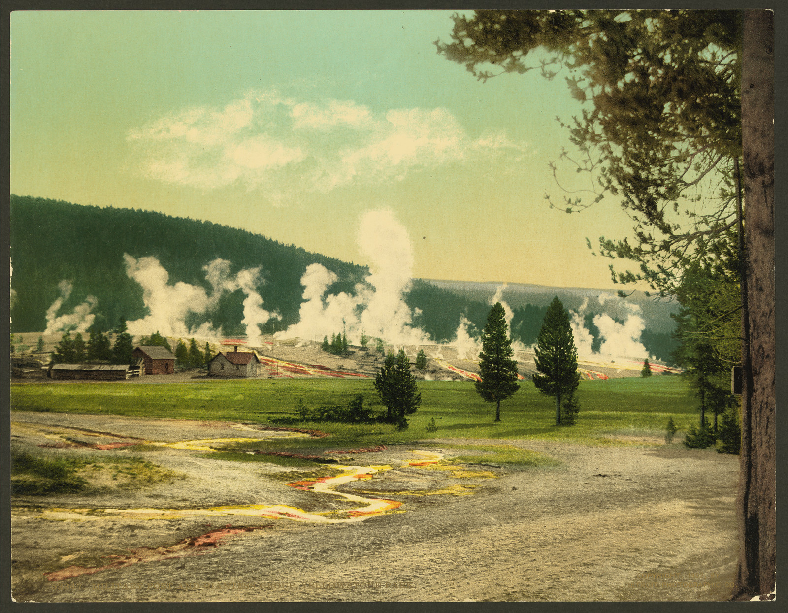 Geyser steam and log buildings, Yellowstone Park — historic image
