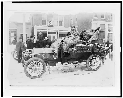 [Four men in automobile, on snow-covered street, on the New York to San Francisco leg of the 1908 New York to Paris automobile race]