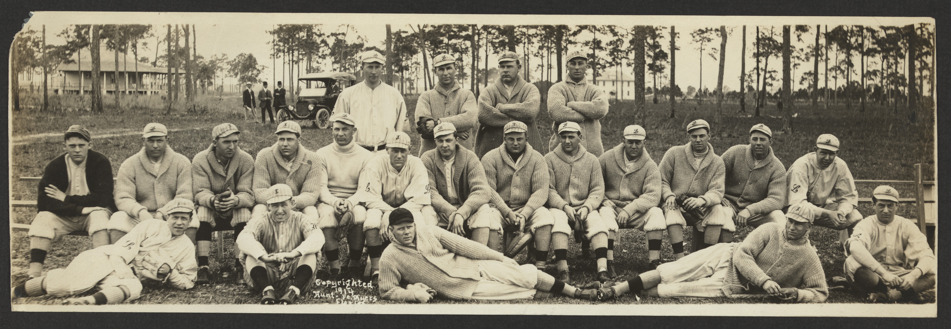 Baseball team panorama, players seated and standing in sweaters — historic image
