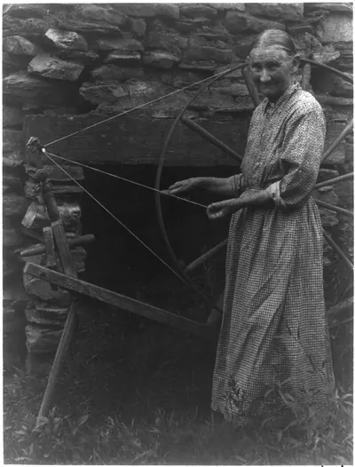 [Woman at spinning wheel]