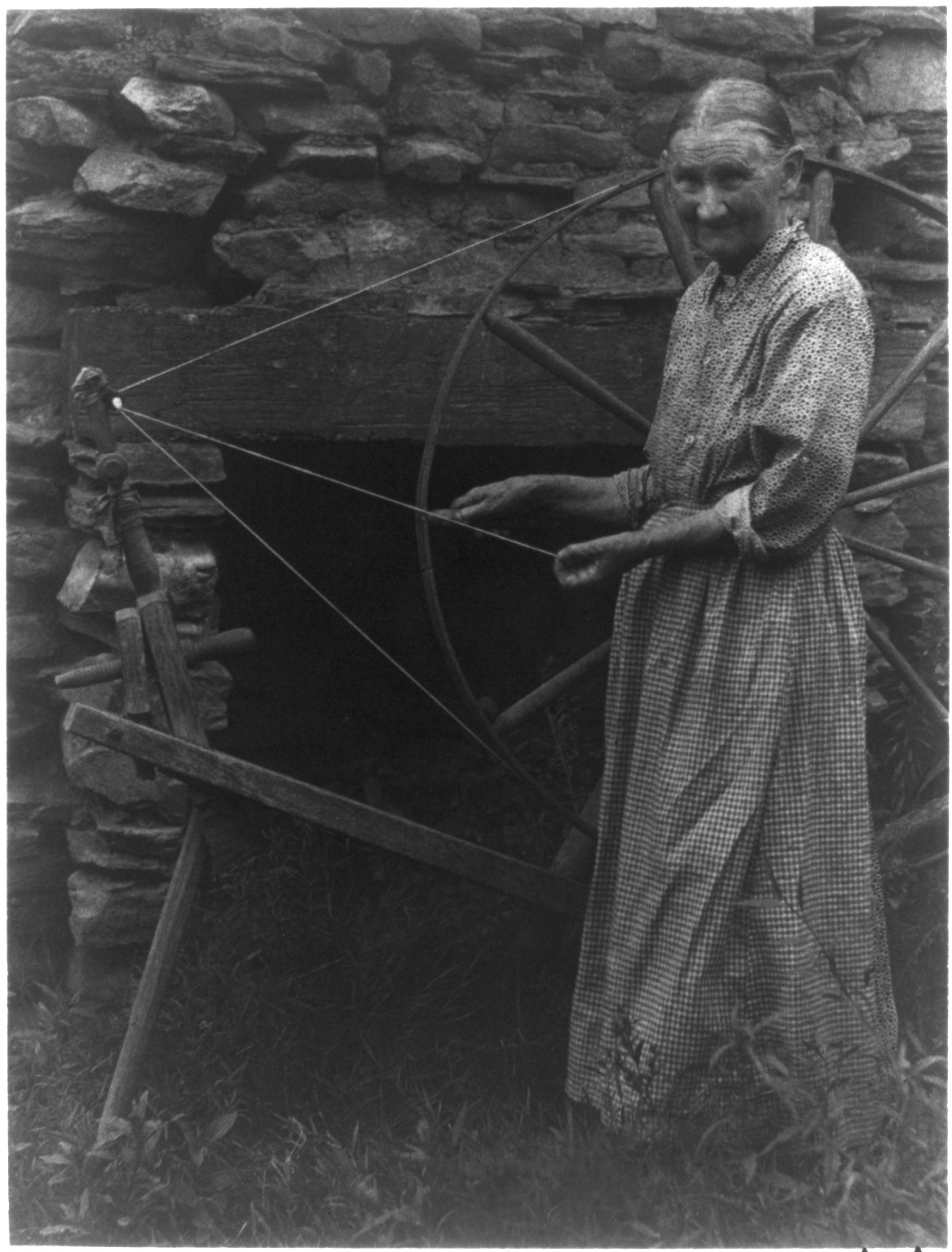 [Woman at spinning wheel], [ca. 1930] — historic photograph