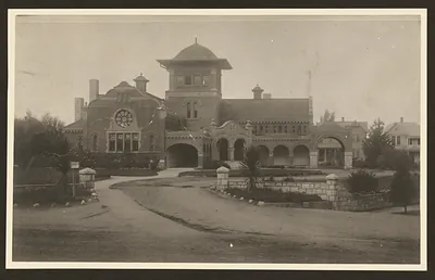 Brick public library building with rose window and tower