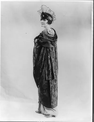 [Woman modeling dress and cloak]