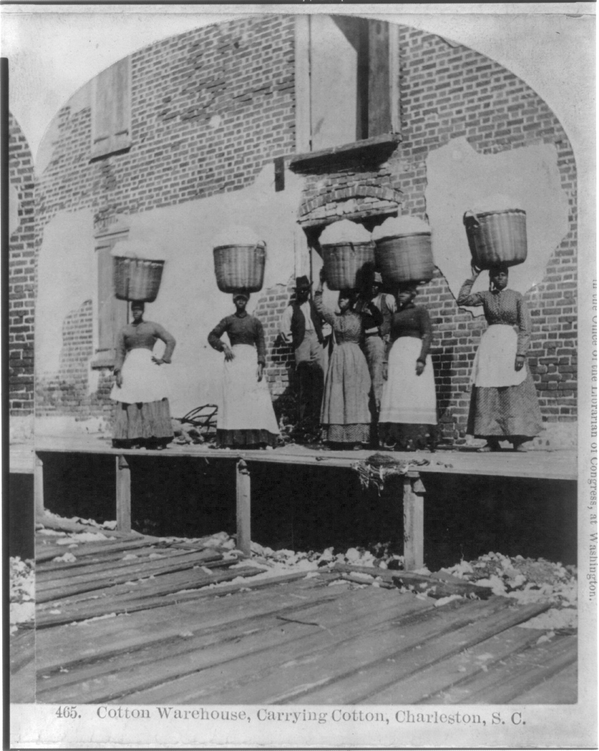 [African Americans working, Charleston, S.C.: Cotton warehouse, carrying cotton], c1879. — historic photograph