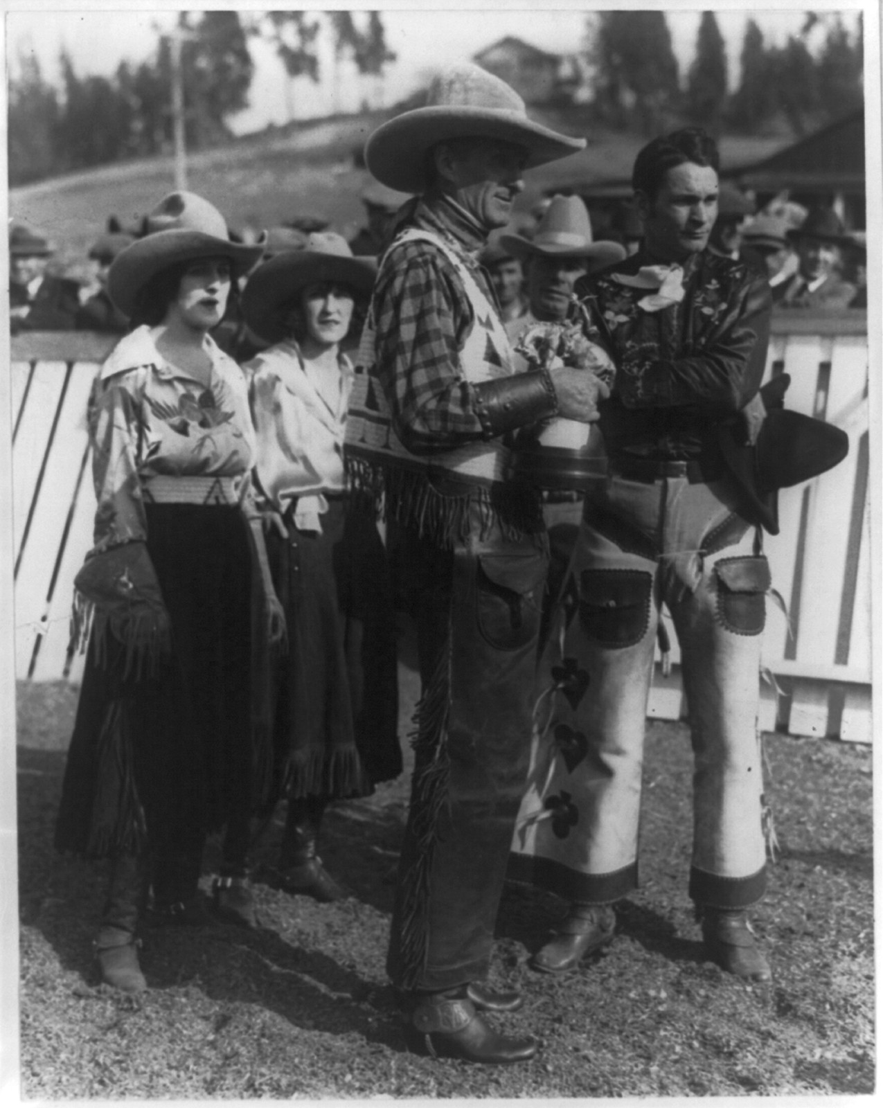 [William Gibbs McAdoo presenting the Roosevelt trophy replica to Yakima Canutt, world champion cowboy. In the rear are Dorothy Morrell, Donna Card Glover and Tommy Grimes, New York City], 1924 Jan. 16. — historic photograph