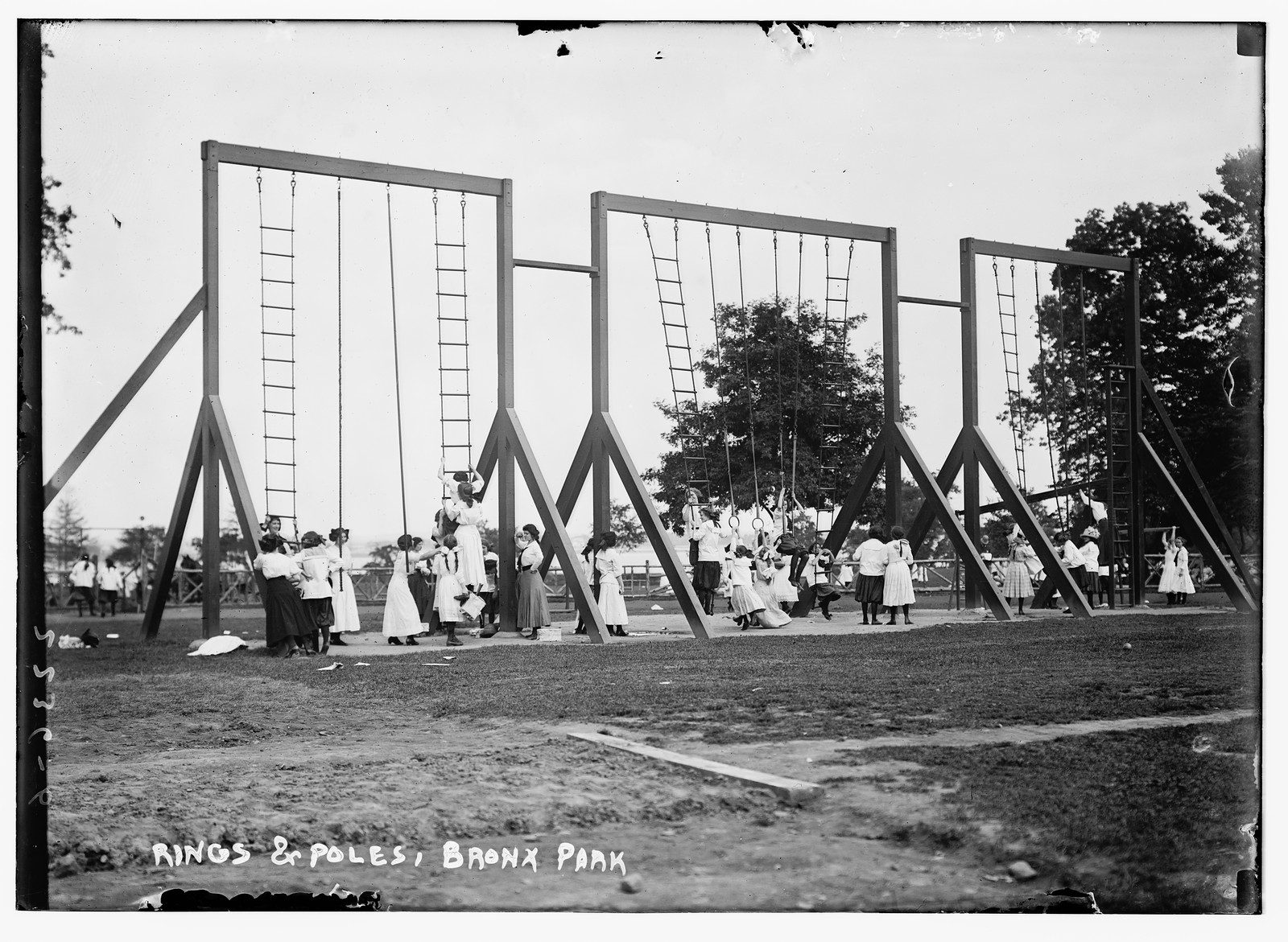 Rings and poles, Bronx Park children playing, n/a — historic photograph
