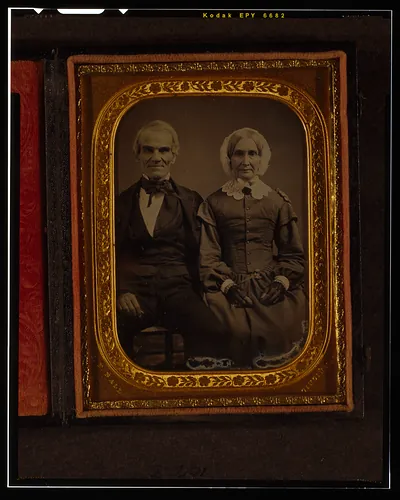 [Unidentified man and woman, three-quarters length portrait, seated]
