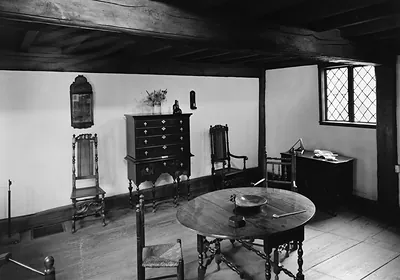 Interior of a historic room with a chest, table and chairs
