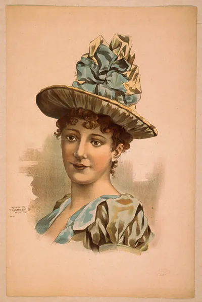 [Head-and-shoulders image of brunette woman, facing right, wearing large blue hat]