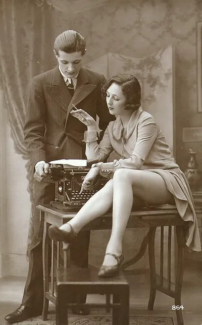 Young couple with typewriter, sepia vintage photograph postcard