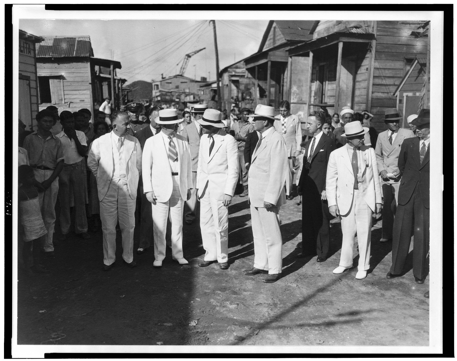 Secretary Ickes and party in the slums of San Juan, 1936 Jan. 8. — historic photograph