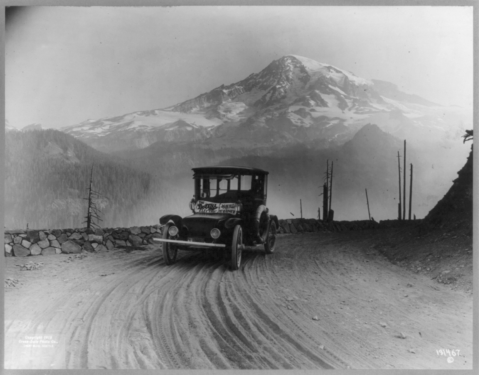 [Detroit Electric" auto on promotional tour through mountains from "Seattle to Mt. Rainier": Mt. Ranier in background]", c1919. — historic photograph