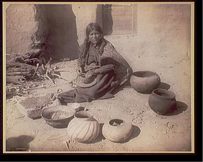 Hopi woman making pottery