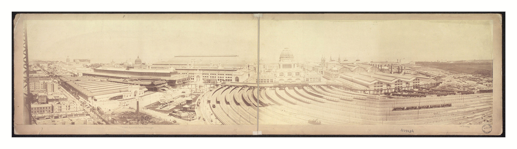 Panoramic view of fair grounds with domed building and railway tracks — historic image