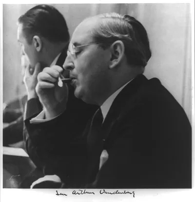 [Arthur Hendrick Vandenberg, 1884-1951, head and shoulders, lighting cigar, left profile]