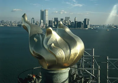 Statue of Liberty torch with Lower Manhattan skyline