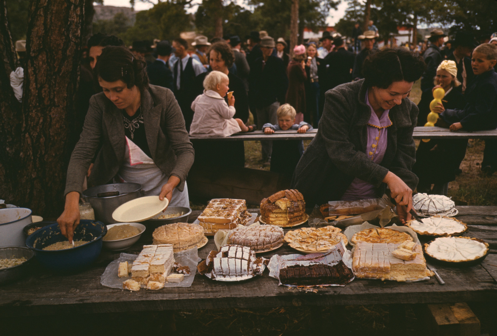 Cutting the Pies and Cakes at the Barbeque Dinner, Pie Town, New Mexico Fair, October, 1940 — historic image