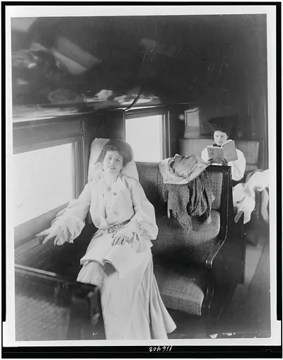 [Two women reading in railroad passenger car]