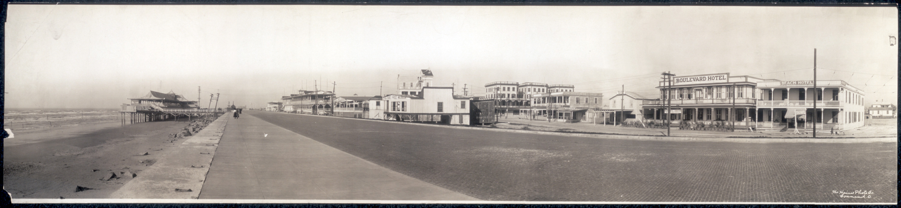 Panoramic photograph of a beach boulevard with hotel buildings — historic photograph