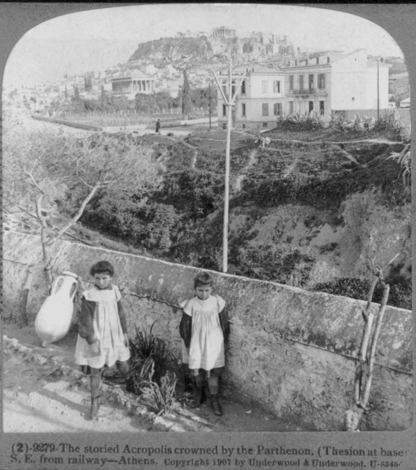 The storied Acropolis crowned by the Parthenon, (Thesion at base) S.E. from railway - Athens, c1907. — historic photograph