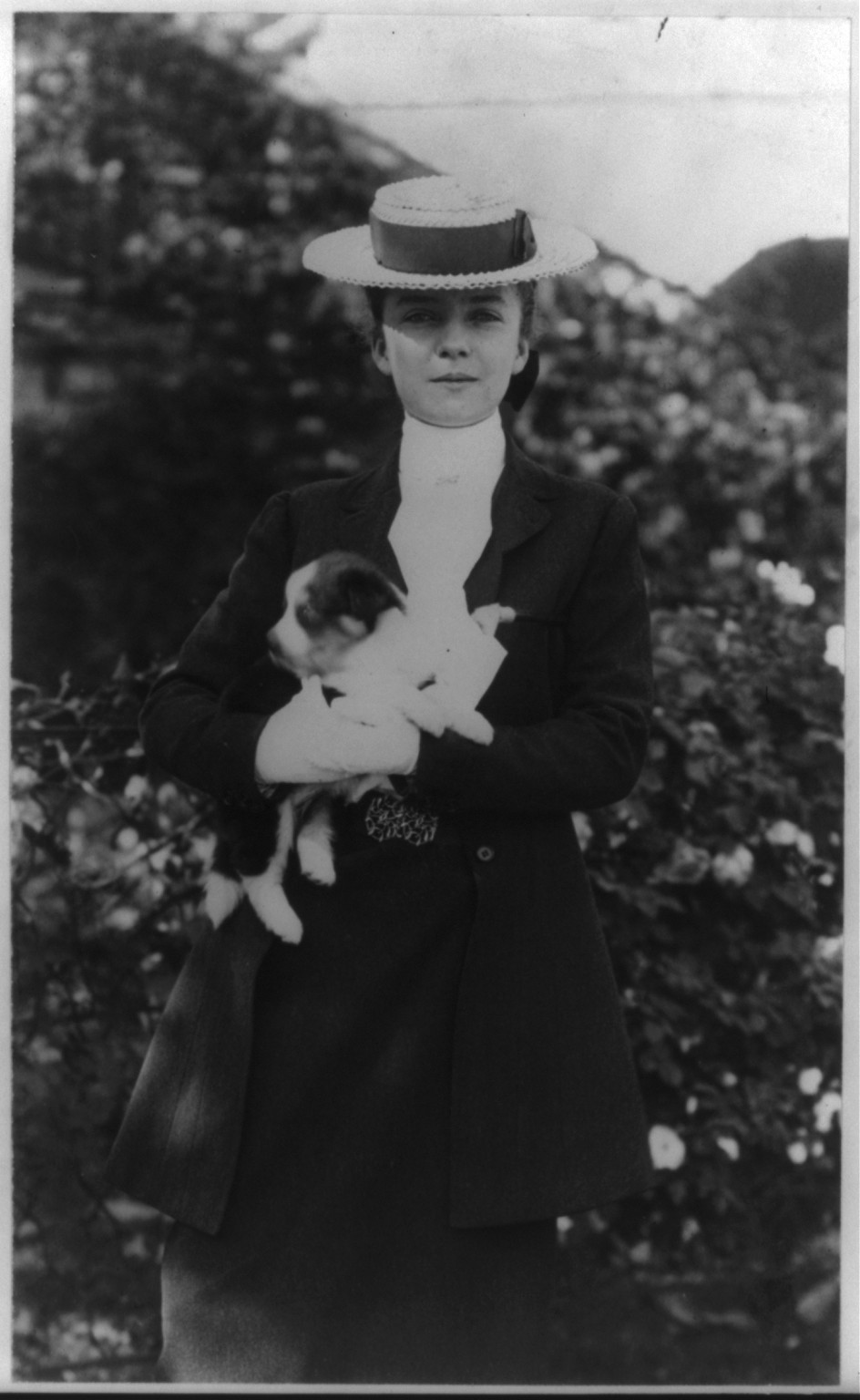 Alice Roosevelt in riding clothes, with dog, c1902 June 17. — historic photograph