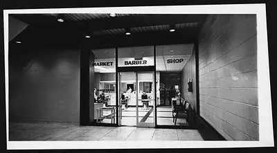 MARKET BARBER SHOP storefront with glass doors and barber chairs