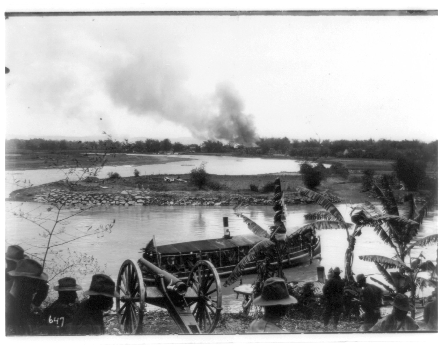 [Philippine insurrection]: Burning of Pasig, Hawthorne Battery and gunboat in foregrd., c1899. — historic photograph