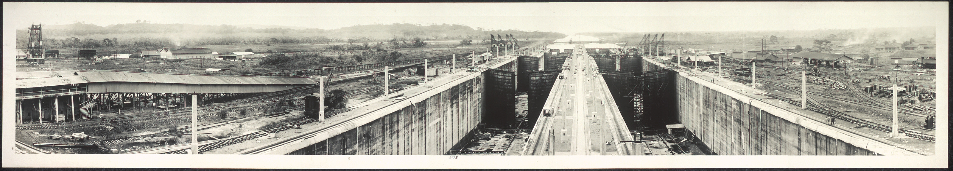 Panoramic view of canal locks with concrete walls and gates — historic image