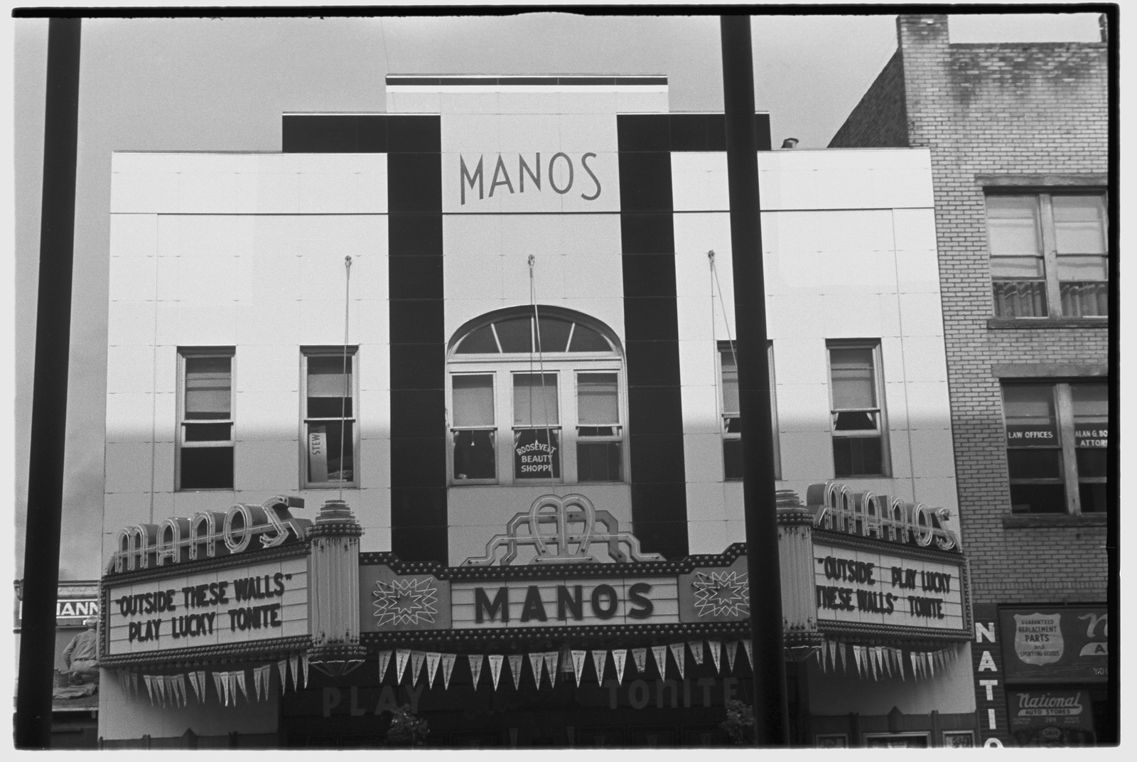 Manos theater facade with marquee, black and white photograph — historic photograph