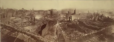 Panoramic photograph of a fire-ravaged city with ruins