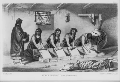 Woman grinding corn. Pueblo Zuni