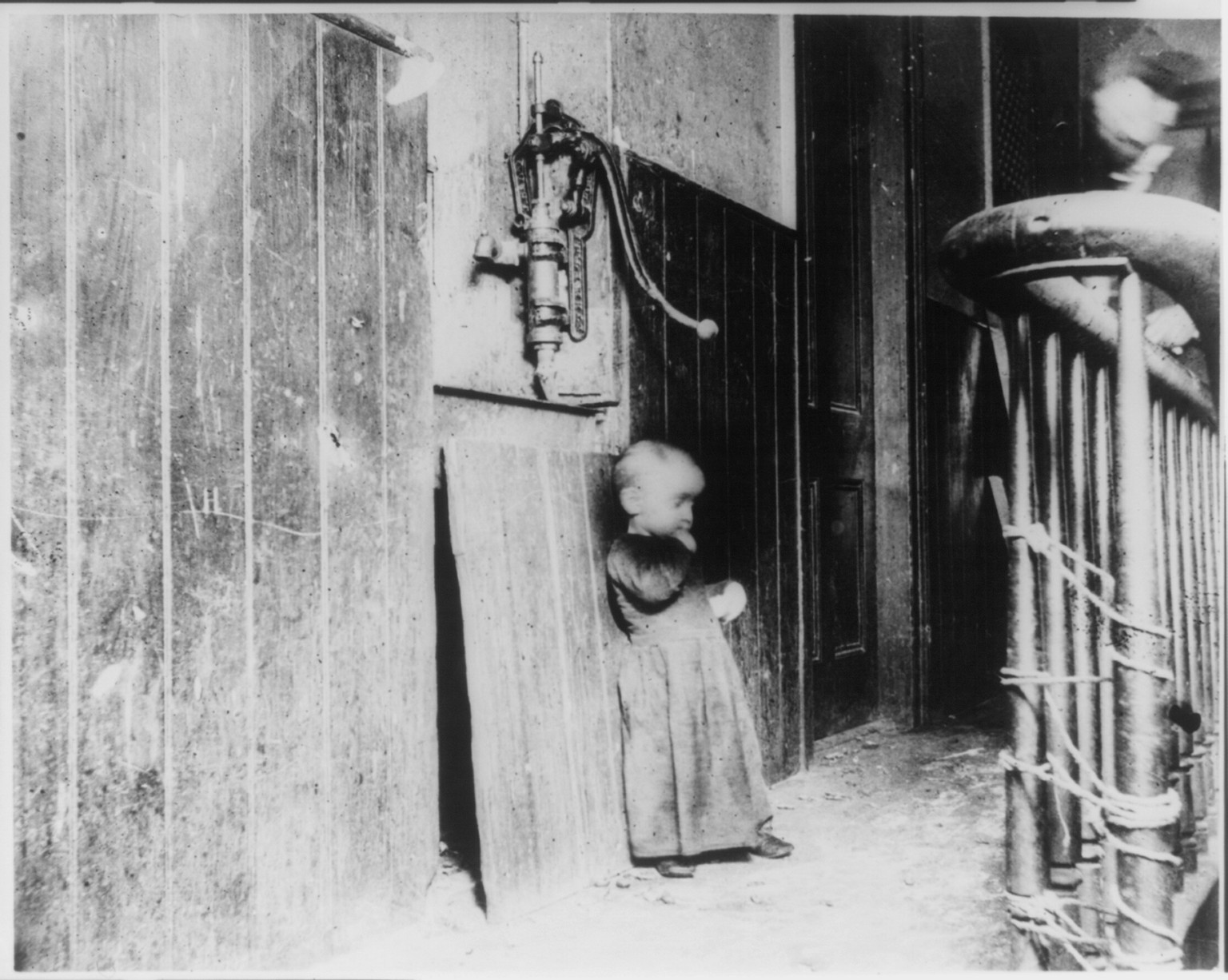 Baby in slum tenement hallway, N.Y.C., [ca. 1888 or 1889] — historic photograph