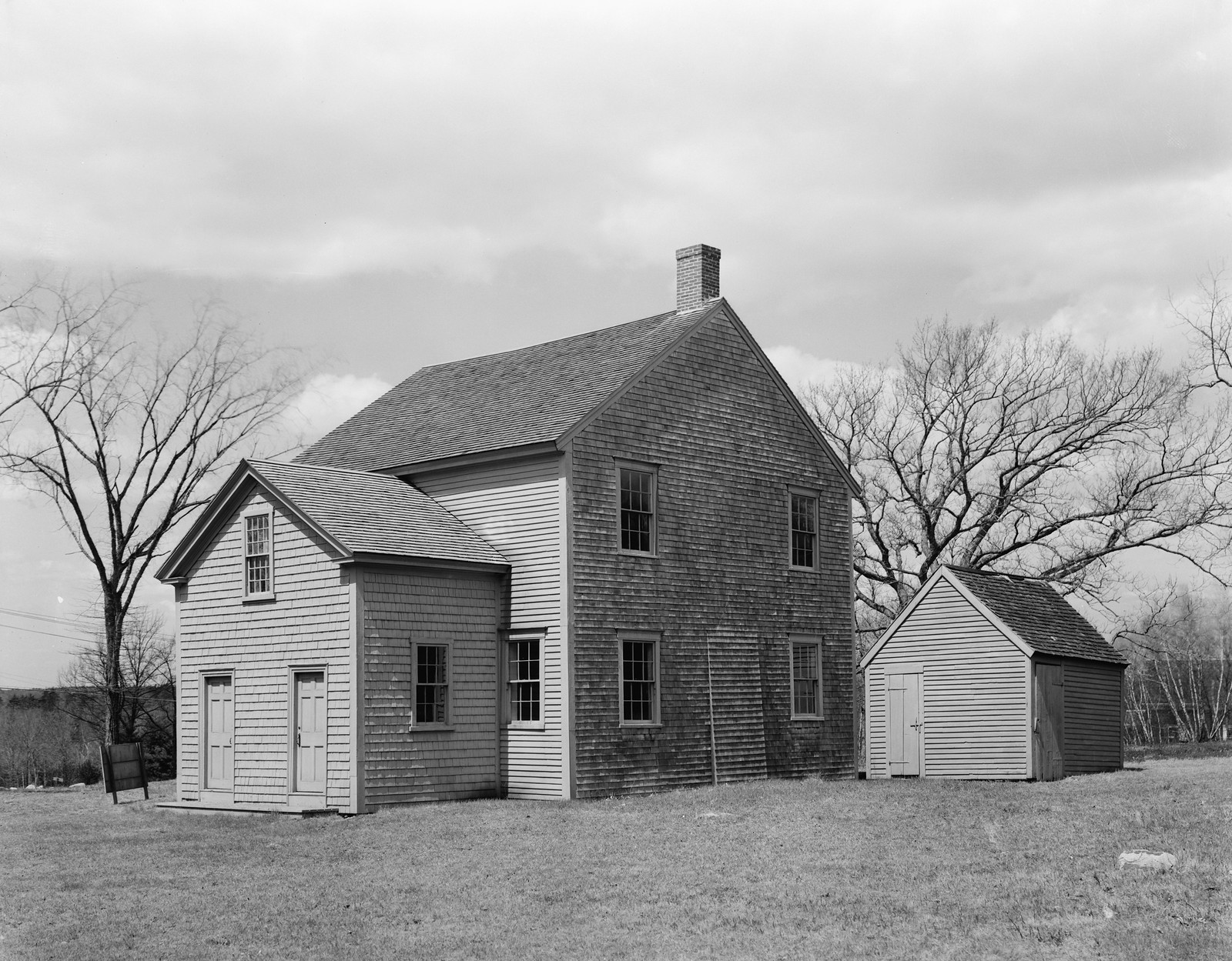 Shingled colonial house with outbuilding, black and white photograph — historic photograph