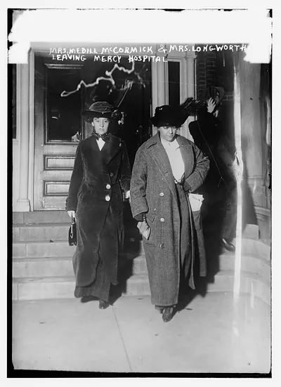Mrs. Medill McCormick and Mrs. Longworth leaving Mercy Hosp., Jan 17, 1910