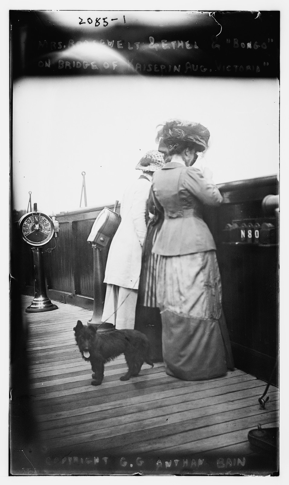 Mrs. Roosevelt and Ethel and "Bongo" on bridge of Kaiserine Aug. Victoria, n/a — historic photograph