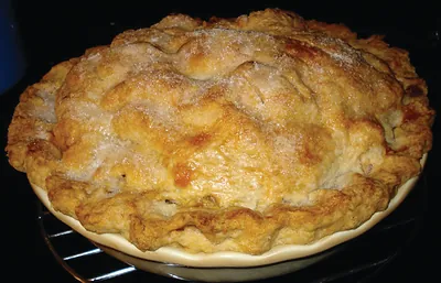 Baked pie with sugared crust on wire rack
