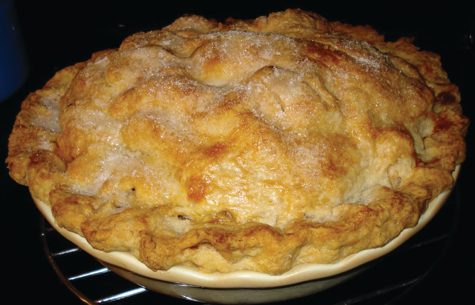 Baked pie with sugared crust on wire rack — historic image