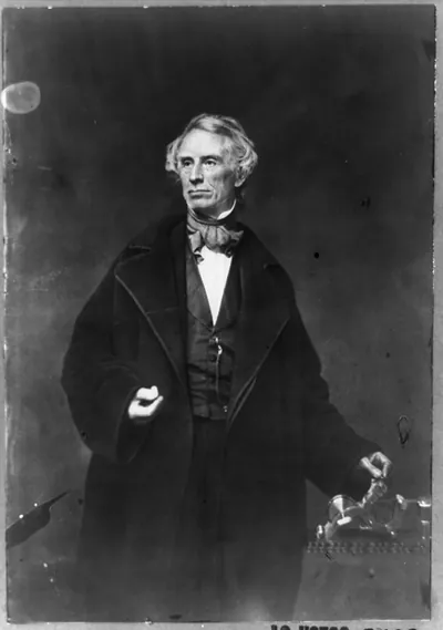 [Samuel F.B. Morse, half-length portrait, posing with left hand on a telegraph apparatus, facing slightly left]