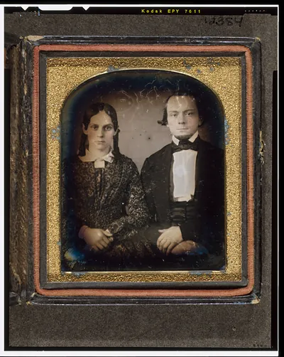 [Unidentified man and woman, seated, facing front]
