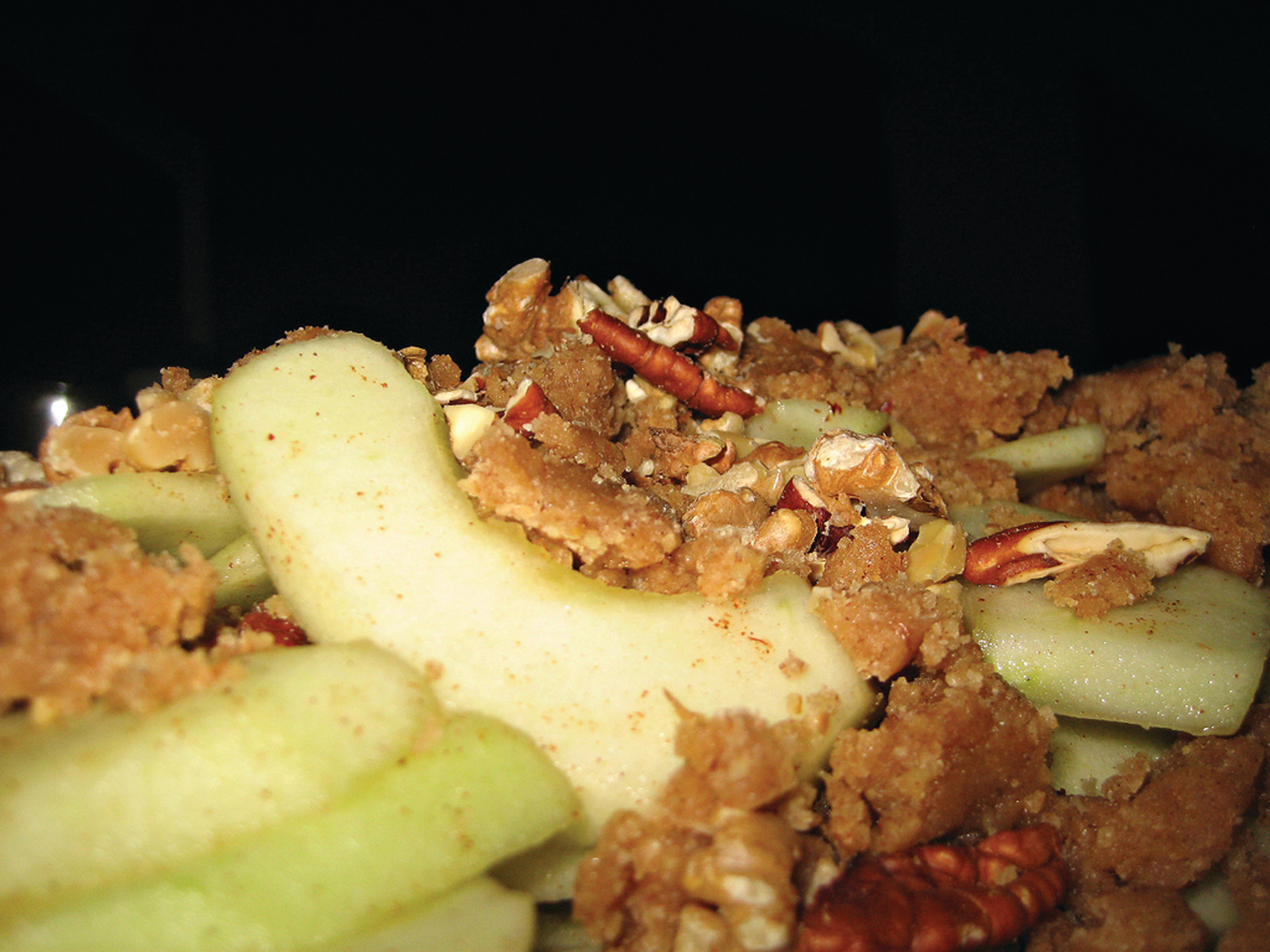 Sliced apples with crumble topping and pecans — historic image