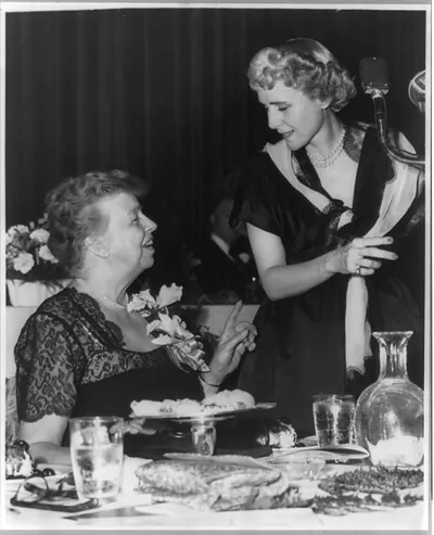[Eleanor Roosevelt Roosevelt, 1884-1962, half length portrait, seated at table, right profile, facing Mrs. Clare Boothe Luce at microphone, at Manhattan's Waldorf-Astoria]